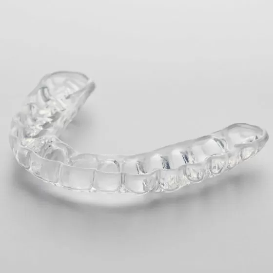 How does the dual laminate night guard help with jaw pain?